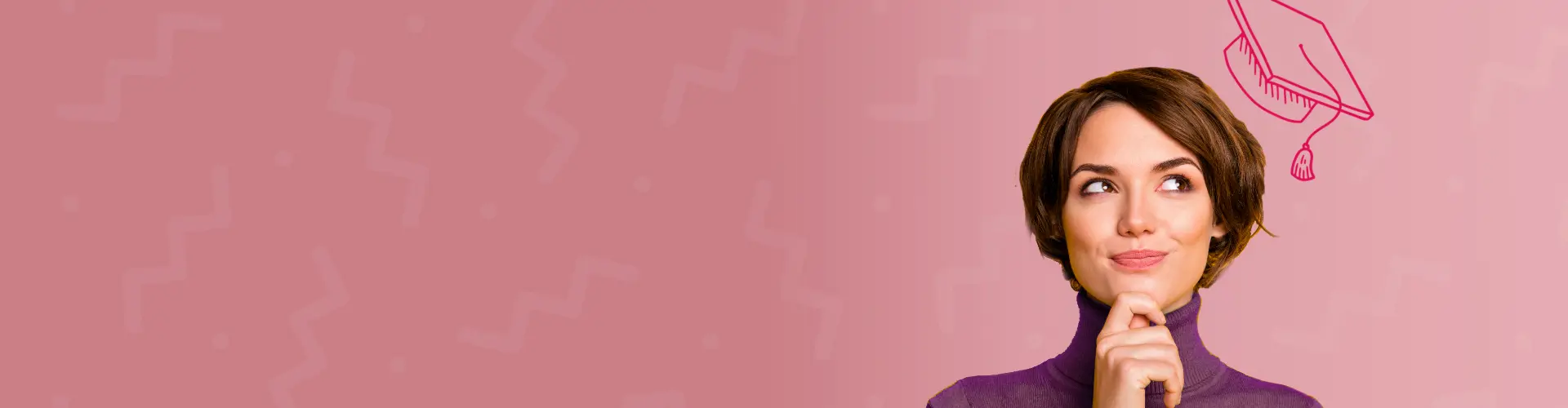 A woman smiles wearing an illustrated graduation cap